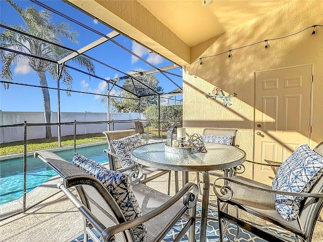 exterior space featuring glass enclosure and a fenced in pool