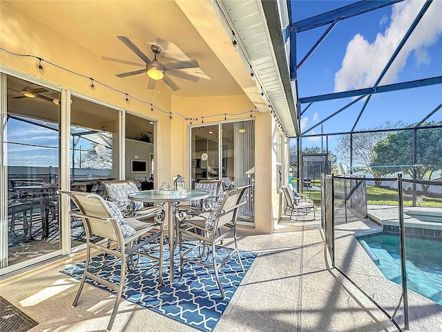 view of patio featuring ceiling fan, a lanai, and a pool with hot tub