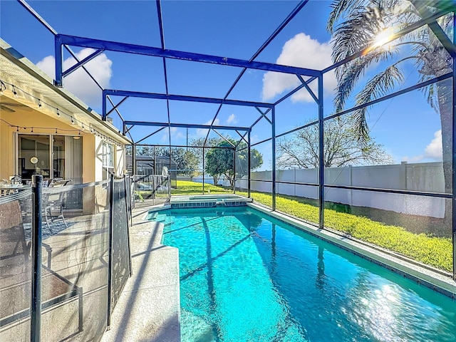 view of swimming pool with a patio area, a lanai, and an in ground hot tub