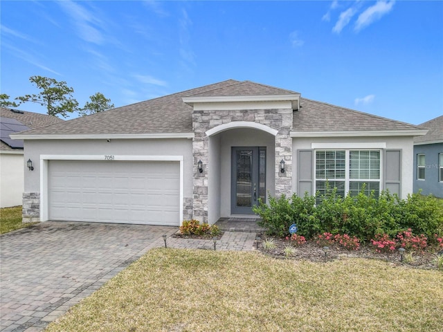 ranch-style house with a front yard and a garage