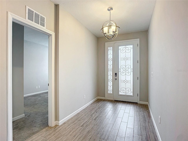 foyer with a notable chandelier and plenty of natural light