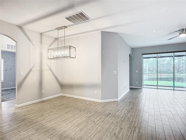 spare room with ceiling fan and a textured ceiling