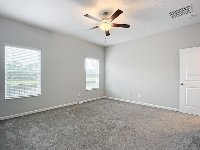 carpeted spare room with ceiling fan