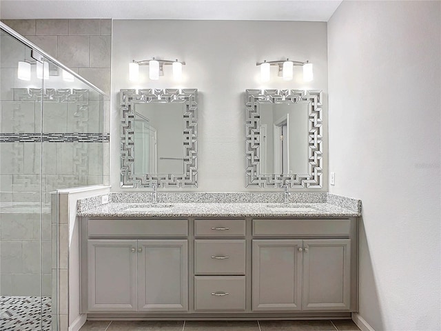 bathroom with vanity, tile patterned floors, and a shower with shower door