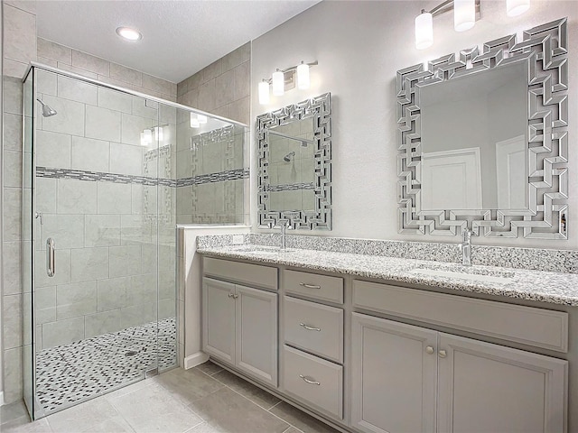 bathroom with walk in shower, tile patterned floors, and vanity