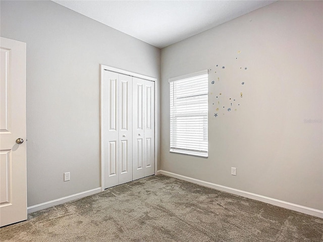 unfurnished bedroom with a closet and carpet