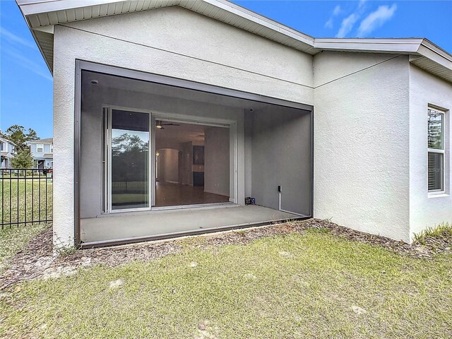 rear view of property with a lawn