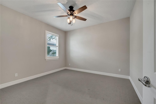 unfurnished room with ceiling fan and carpet