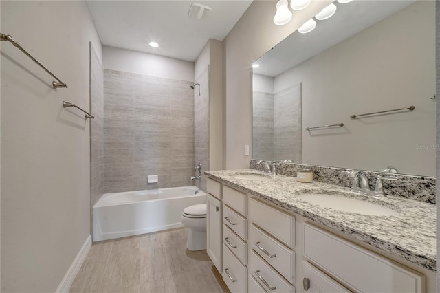 full bathroom with tiled shower / bath combo, vanity, and toilet