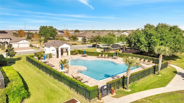 view of swimming pool featuring a yard and a patio