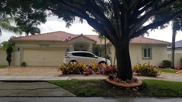 mediterranean / spanish-style house with a garage