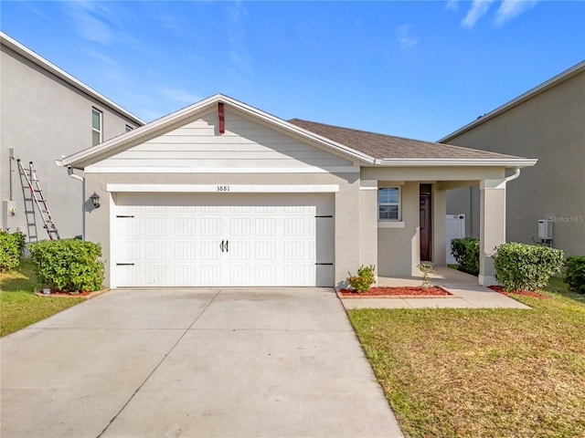 view of front of home featuring a front lawn and a garage