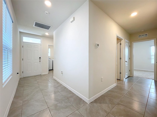 tiled foyer featuring washer / clothes dryer