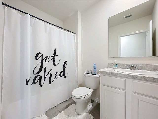 bathroom with tile patterned floors, vanity, and toilet