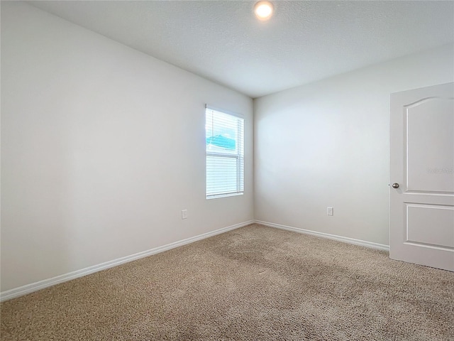 carpeted spare room with a textured ceiling