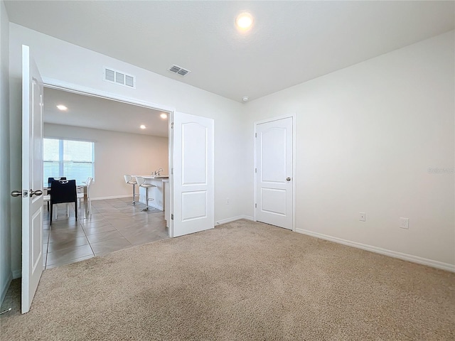 empty room featuring light carpet