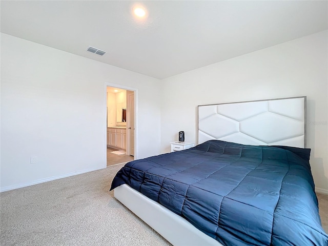 carpeted bedroom with ensuite bath