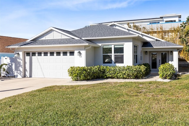 view of front of property featuring a garage and a front lawn