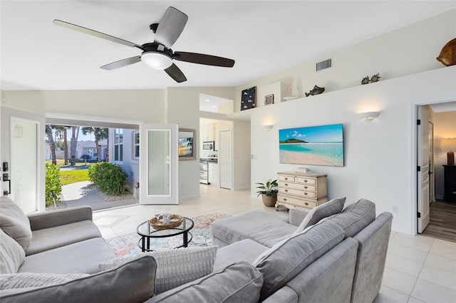 tiled living room featuring ceiling fan and lofted ceiling