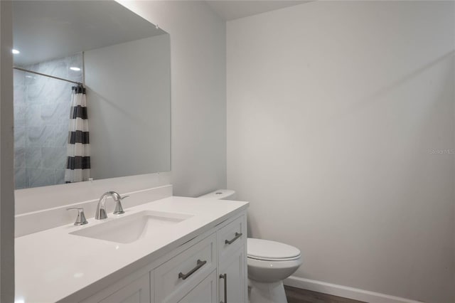 bathroom featuring toilet, vanity, hardwood / wood-style floors, and a shower with shower curtain