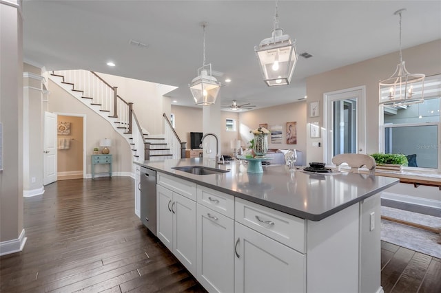 kitchen with ceiling fan, sink, dishwasher, white cabinetry, and an island with sink