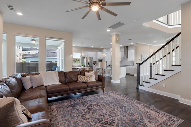 living room featuring ceiling fan and dark hardwood / wood-style flooring