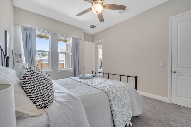 bedroom featuring light colored carpet and ceiling fan