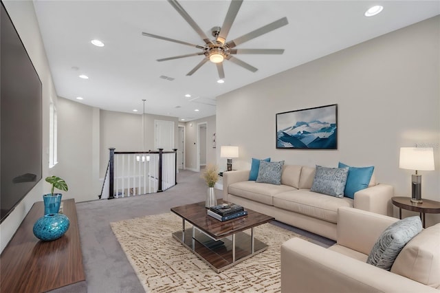 carpeted living room with ceiling fan