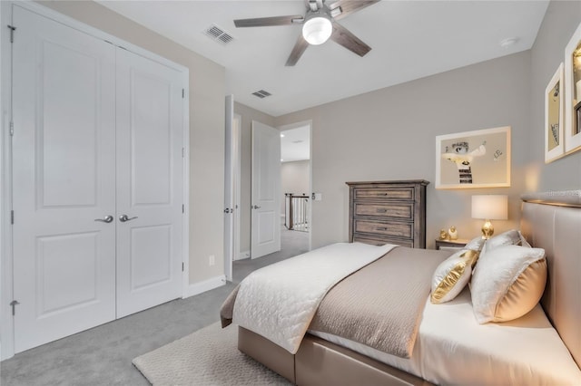 carpeted bedroom with a closet and ceiling fan