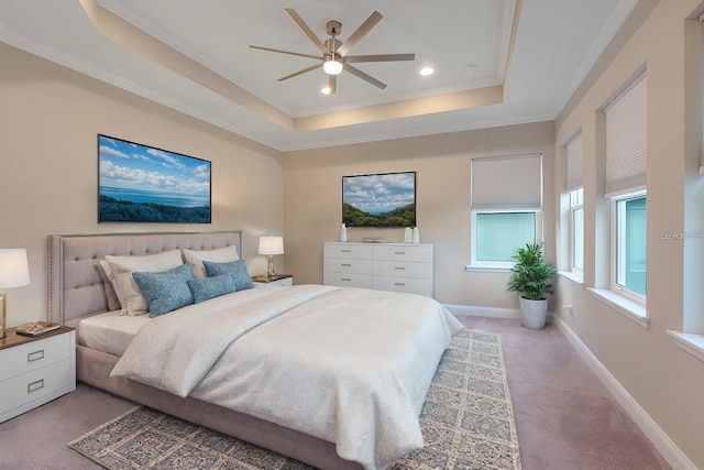 bedroom featuring a raised ceiling, ceiling fan, carpet flooring, and ornamental molding