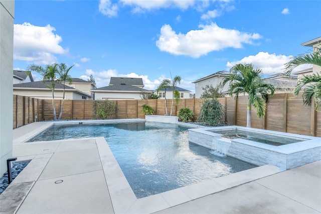 view of swimming pool with pool water feature and an in ground hot tub