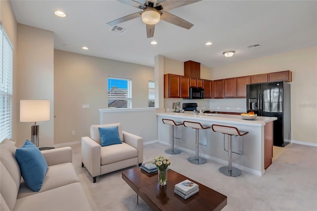 living room with light colored carpet and ceiling fan