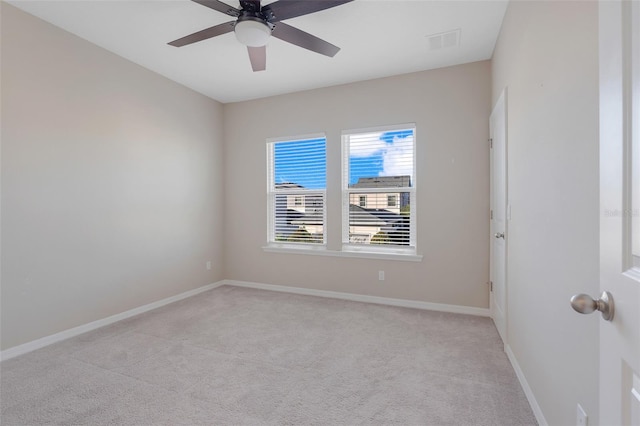 carpeted spare room with ceiling fan