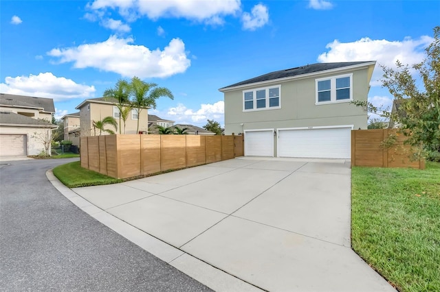 view of front of house with a garage and a front lawn