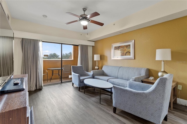 living room featuring hardwood / wood-style floors and ceiling fan