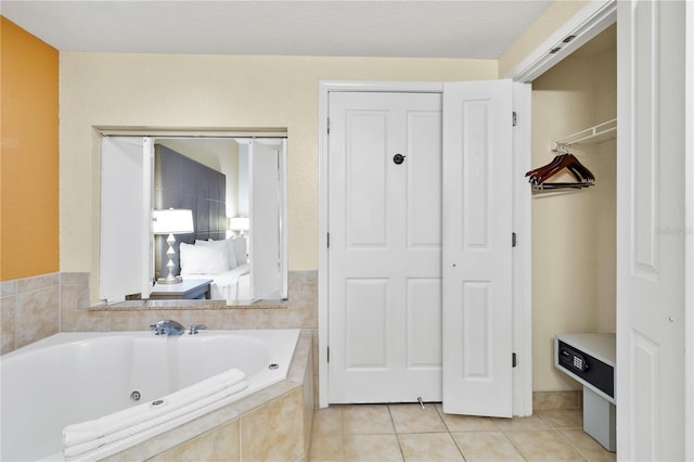 bathroom featuring tile patterned floors and tiled bath