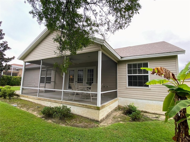 rear view of property featuring a yard