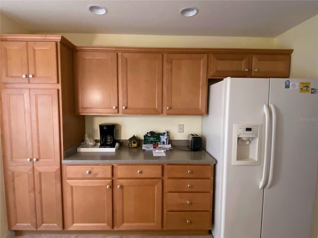 kitchen featuring white fridge with ice dispenser