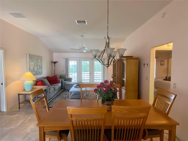 dining area featuring french doors, ceiling fan with notable chandelier, and vaulted ceiling