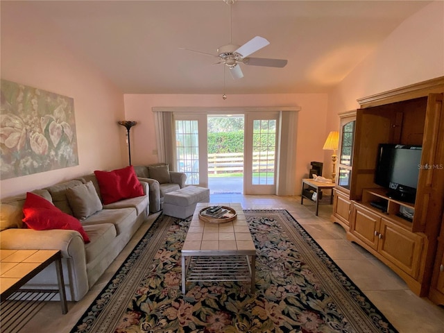 tiled living room with ceiling fan and lofted ceiling