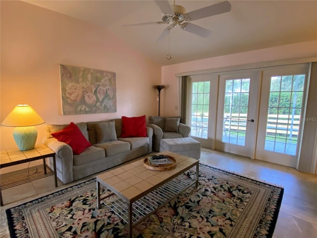 tiled living room featuring ceiling fan, lofted ceiling, and french doors