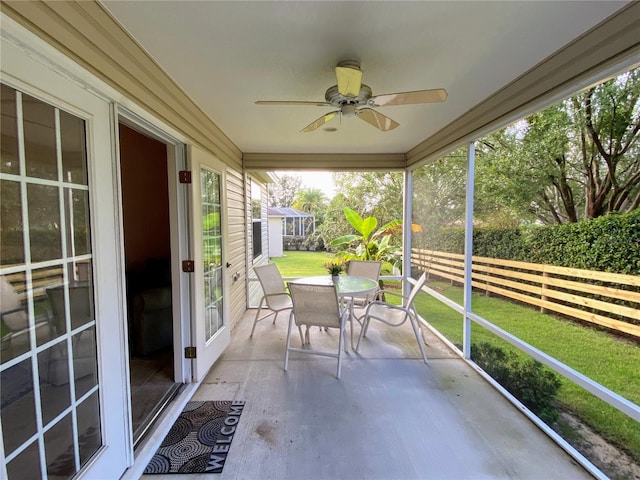 sunroom / solarium featuring ceiling fan