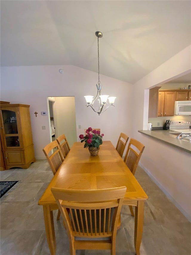 dining room featuring lofted ceiling and an inviting chandelier