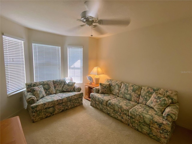 carpeted living room featuring ceiling fan