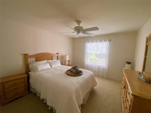 bedroom featuring ceiling fan and light carpet