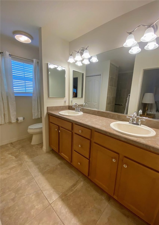 bathroom featuring vanity, toilet, and a chandelier