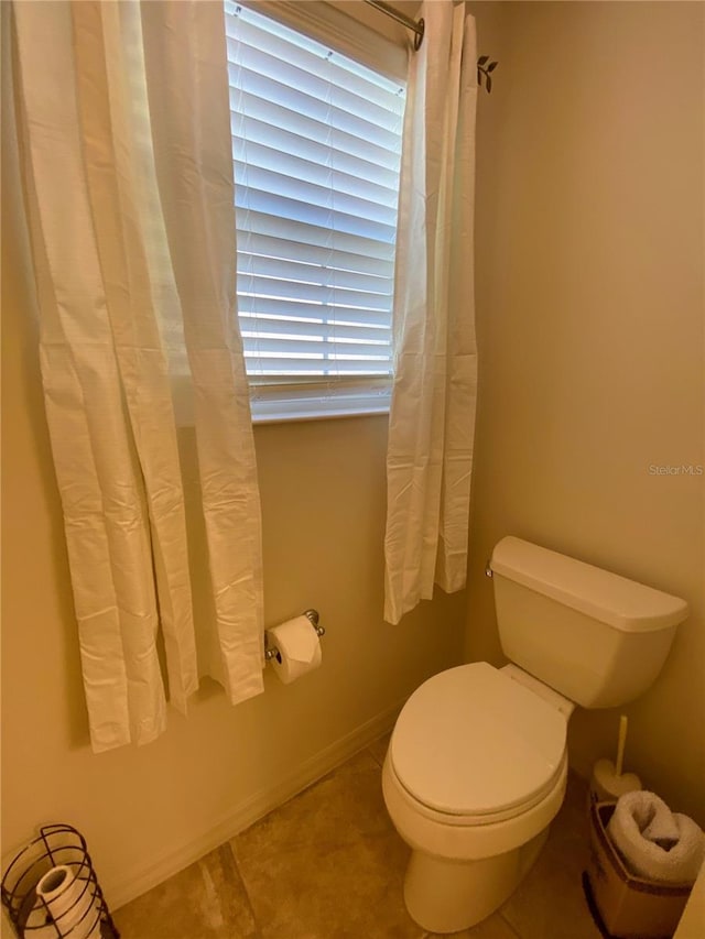 bathroom featuring tile patterned flooring and toilet