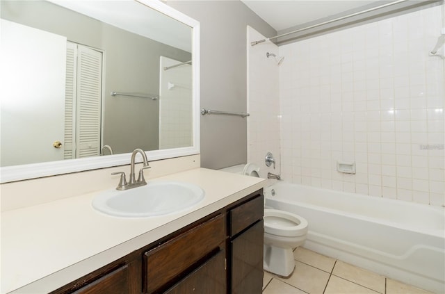 full bathroom featuring tile patterned flooring, vanity, toilet, and tiled shower / bath