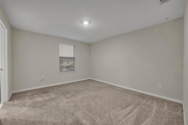 unfurnished room with light colored carpet