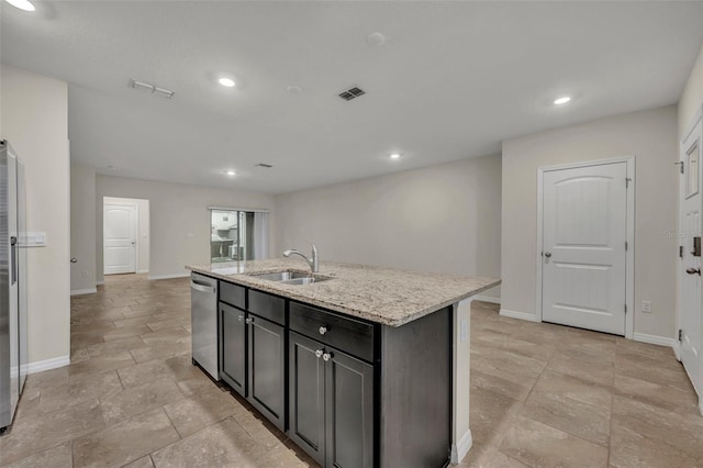 kitchen with a center island with sink, dishwasher, light stone counters, and sink